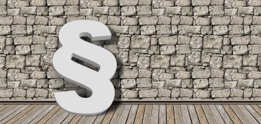 Steinmauer im Hintergrund und ein  weißes Paragraphenpiktogramm im Vordergrund