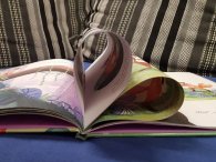 Bilderbuch auf Sofa, Seiten in herzform