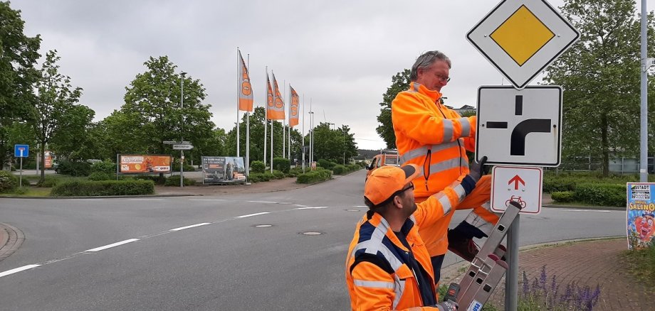 Die Mitarbeiter des städtischen Bauhofes passen die Vorfahrtsbeschilderung an. 