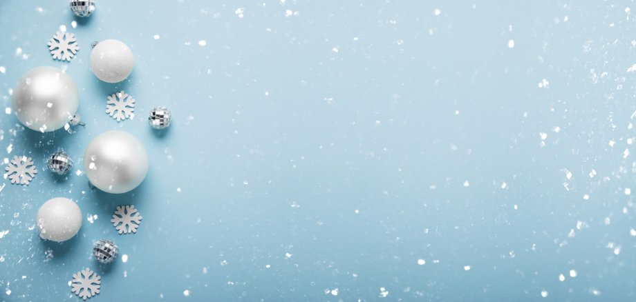 Merry Christmas and Happy Holidays greeting card, frame, banner. New Year. Noel. Christmas white ornaments on blue background top view. Winter xmas holiday theme. Flat lay.