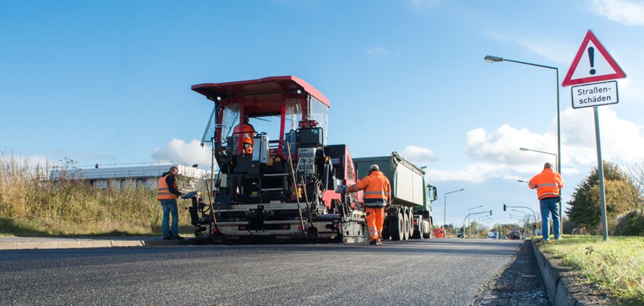 Straßenbau Zu sehen ist eine Straße, an der Bauarbeiten stattfinden. Es sind Maschinen zu sehen
